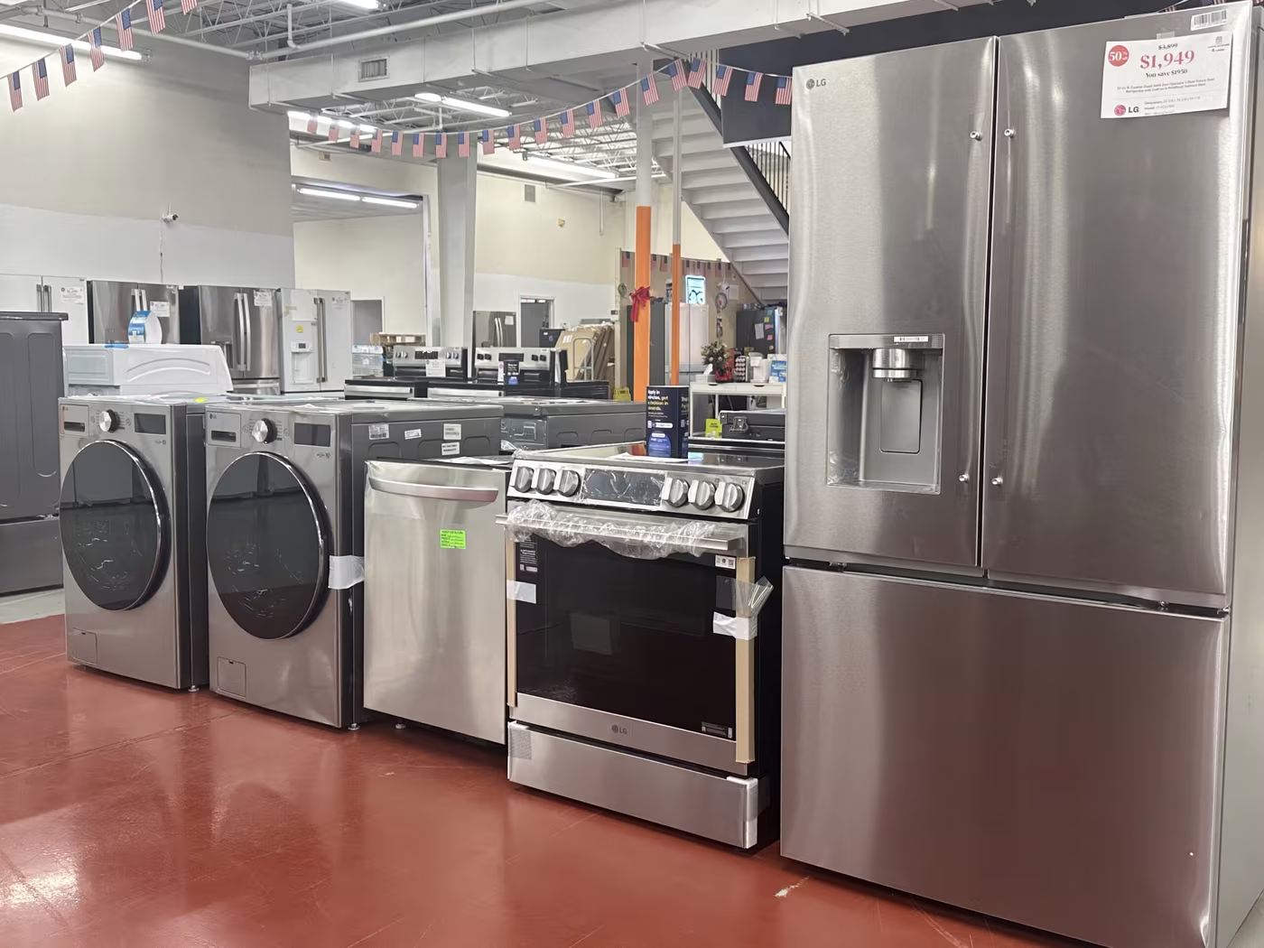 A stainless kitchen suite — refrigerator, range, dishwasher and laundry pair